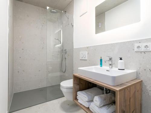 a bathroom with a sink and a toilet at Hopfgarten Alpin Living Top 6 in Hopfgarten im Brixental