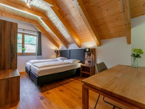 a bedroom with a bed and a wooden ceiling at Im grünen Herzen in Donnersbachwald