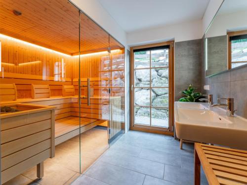 a bathroom with a shower and a sink and a tub at Im grünen Herzen in Donnersbachwald