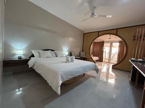a bedroom with a large bed and a large window at El Nido, Corong Corong Pier in El Nido