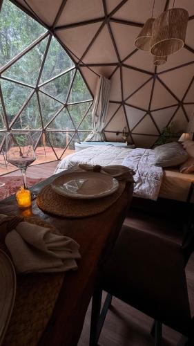 a room with a bed and a table in a tent at Cabana winchesters - Domo in Cascavel
