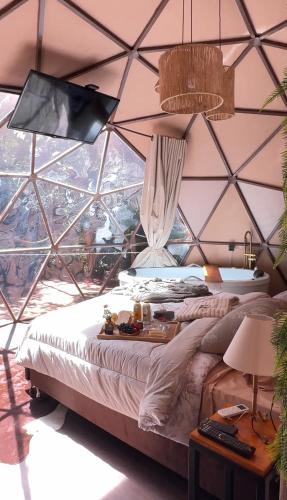 a bedroom with a large bed in a tent at Cabana winchesters - Domo in Cascavel