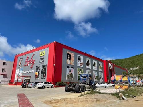 a red building with pictures on the side of it at Excellent 2-Bedroom Condo in Gated Community in Philipsburg