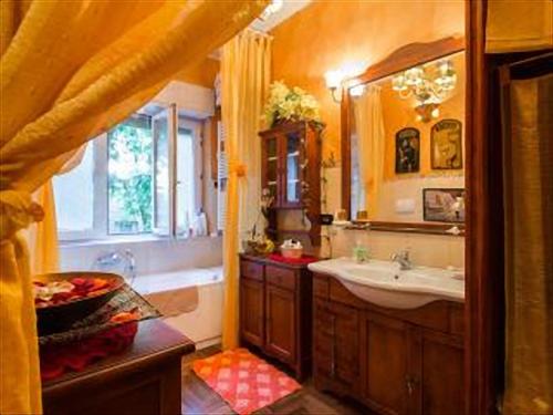 a bathroom with a sink and a tub and a mirror at Romantic & Artistic Apartment in Milan
