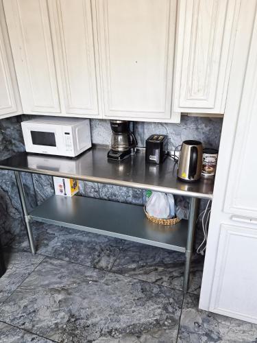 a kitchen counter with a microwave oven on a shelf at Soul in Los Angeles close to Downtown in Los Angeles