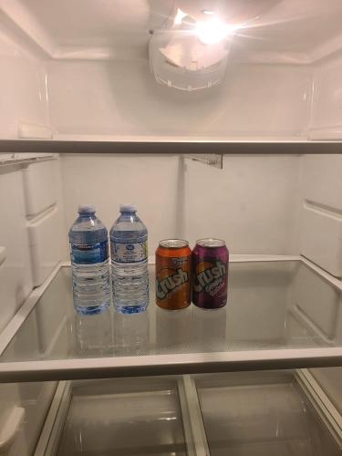 three cans of water in an open refrigerator at Private One Bedroom Basement Apartment with Separate Entrance in Dieppe