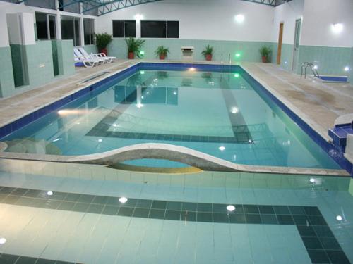 a large swimming pool in a large building at Hosteria Quinta San Miguel in Ibarra