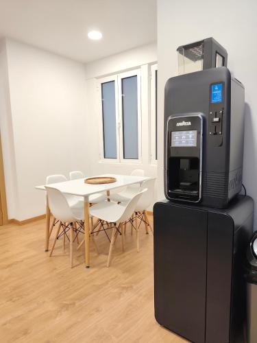 an office with a printer and a table with chairs at Misericórdia Rooms in Guarda