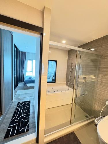 a bathroom with a shower and a toilet and a tub at The Sriracha Perch in Ban Fang Daeng