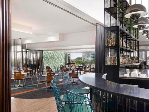 a restaurant with chairs and tables and a bar at Mantra on View in Gold Coast