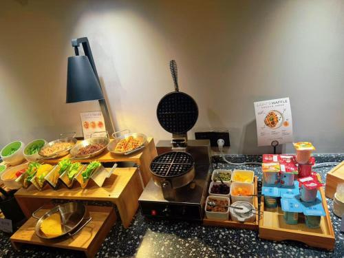 a buffet with many different types of food on display at Atour Light Hotel Shanghai Minhang Maqiao in Shanghai