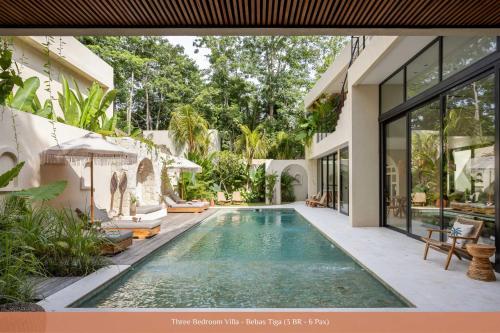 a swimming pool in the backyard of a house at Bebas Villas - Uluwatu, Bali in Uluwatu