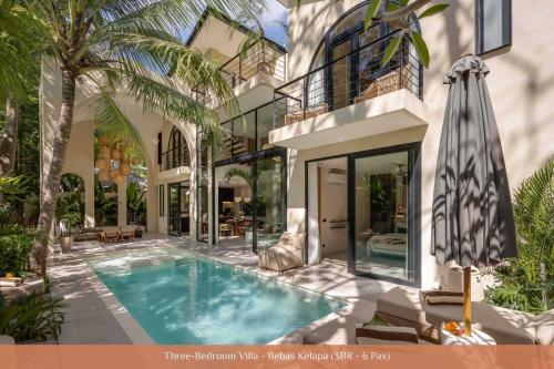 a villa with a swimming pool and a house at Bebas Villas - Uluwatu, Bali in Uluwatu
