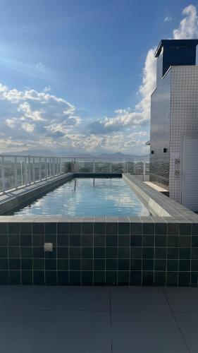 a large swimming pool on top of a building at Apartamento Novo in Capão da Canoa