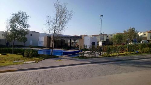 un edificio con piscina en medio de una calle en House A in a residential condominium with a pool, en Miranda