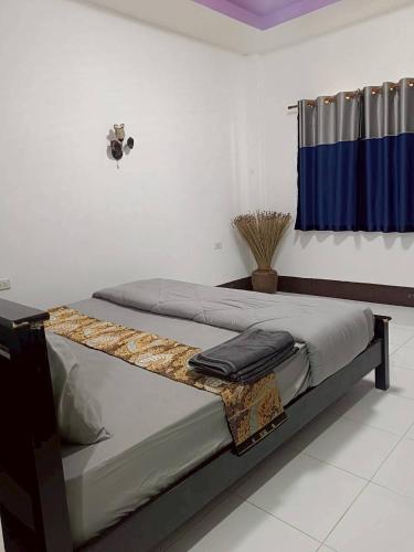 a bedroom with a bed with a table on it at Ploy Chumpoo Lanta in Phra Ae beach