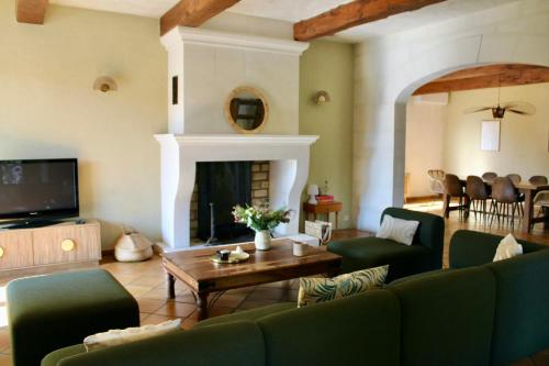 un soggiorno con un divano e un tavolo di Casa Limonella - Maison 12 pers avec piscine a Fontvieille