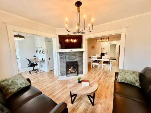 a living room with a couch and a fireplace at The Moncton Muse in Moncton