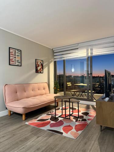 a living room with a couch and a table at Departamento con vista a coquimbo y bahía in Coquimbo