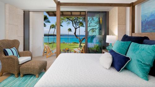 a bedroom with a bed with a view of the ocean at ❤PiH❤ Hapuna Beachfront Bliss Beachfront Steps From Ocean B29 in Hapuna Beach