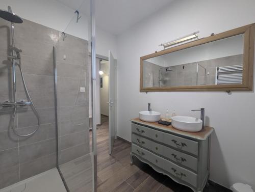 a bathroom with two sinks and a shower at Les champs dessus in Sarrey