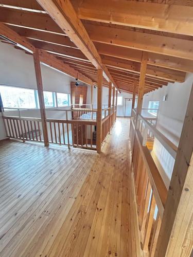 a large room with wooden floors and wooden ceilings at Ajito Niseko in Kutchan