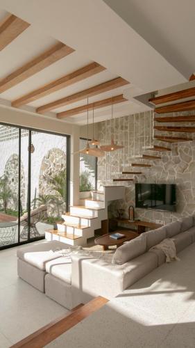 a living room with a couch and a staircase at Casa Amani 3BR Mediterranean w Pool Near Seminyak in Kerobokan