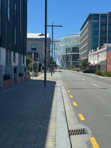 an empty street in a city with buildings at The Mixer - 2 Bed Central City in Christchurch