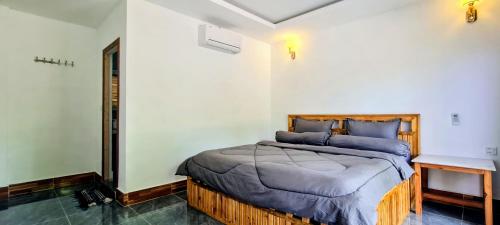 a bedroom with a bed with blue pillows at Koh Rong Lagoon in Koh Rong Island