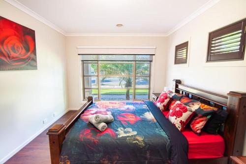 a bedroom with a bed and a large window at Popular Grand Villa Shepparton in Shepparton
