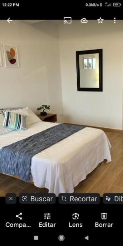 a picture of a bedroom with a bed and a mirror at Habitación Casa Wayllu Pucallpa in Pucallpa