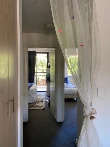a hallway with a curtain in a bedroom at Platform One Guildford in Guildford