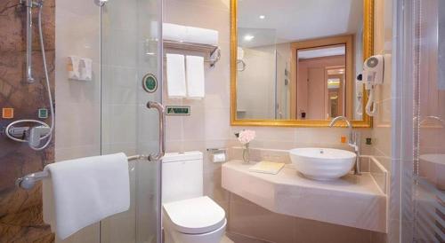 a bathroom with a toilet and a sink and a shower at Vienna Hotel Chengdu Chunxi Road Lijiatuo Metro Station in Chengdu