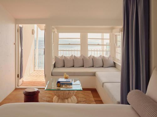 a living room with a couch and a view of the ocean at Il Delfino Seaside Inn in Yamba