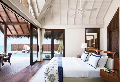 a bedroom in a villa with a bed and a pool at Taj Exotica Resort & Spa, Maldives in South Male Atoll