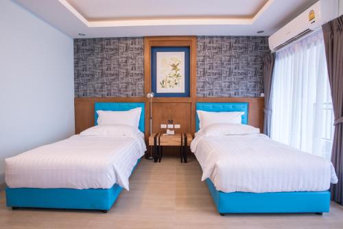 Postel nebo postele na pokoji v ubytování Triple B Boutique Residence