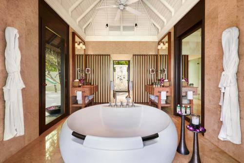 a large bathroom with a large white tub at Taj Exotica Resort & Spa, Maldives in South Male Atoll