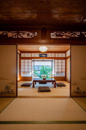 a room with a table in the middle of a room at 宿 重富 Stay SHIGETOMI in Aira