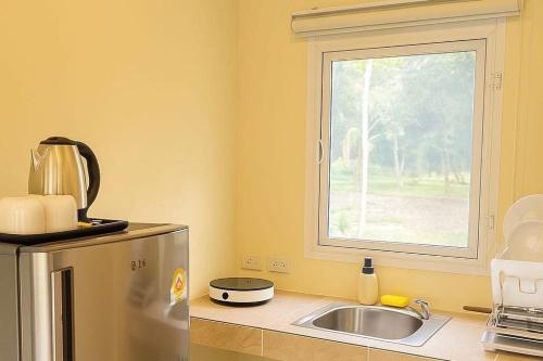 a kitchen with a sink and a window at Bright Sanctuary in Ko Phangan