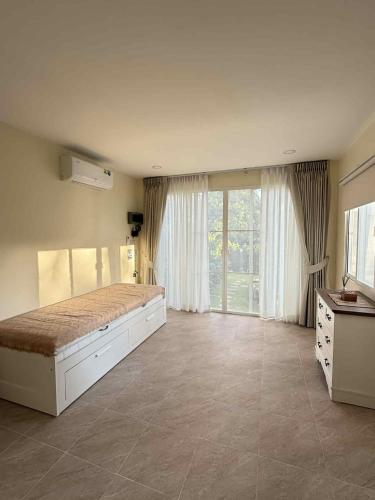 a bedroom with a large bed and a large window at Bright Sanctuary in Ko Phangan
