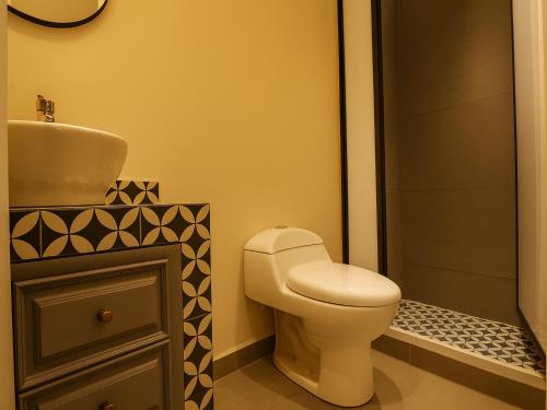 a bathroom with a toilet and a sink at Collection O Hotel Concreta 199 Mexico City in Mexico City