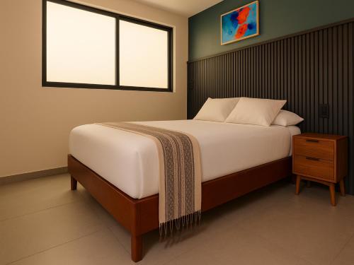 a bedroom with a large bed and a window at Collection O Hotel Concreta 199 Mexico City in Mexico City
