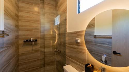 a bathroom with a shower with a mirror at Dono Pool Villa & Spa in Dauis