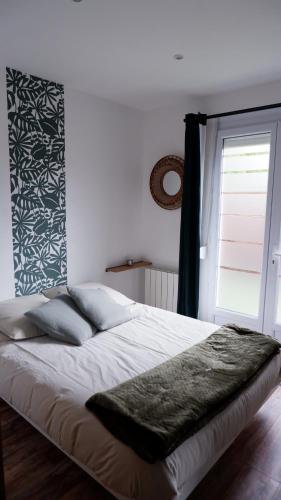 a bedroom with a large bed with a window at A l'étoile du soir in Nançay