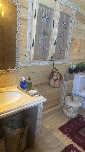 a bathroom with a sink and two windows at Paloma Wooden House !!! in Siwa