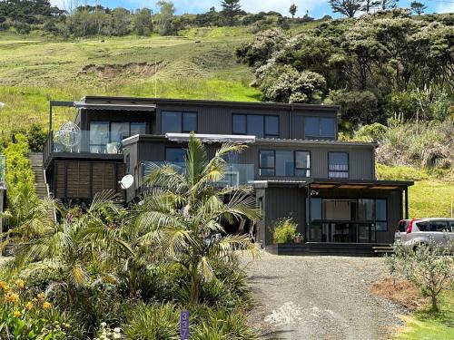a house with a car parked in front of it at Beach view studio 337 in Omapere
