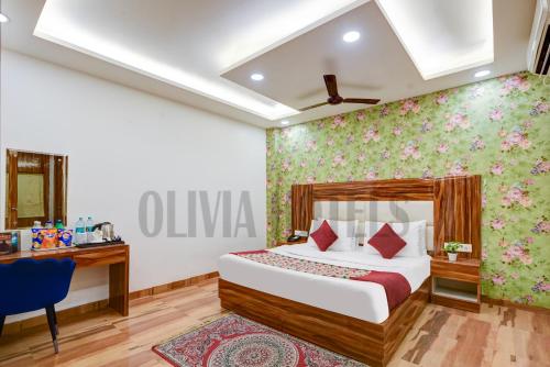 a hotel room with a bed and a desk at Olivia Hotels - Delhi Airport in New Delhi