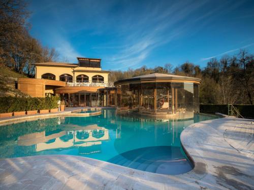 a large swimming pool with a building in the background at Gorgeous Holiday Home in Sorano with Swimming Pool in Sorano