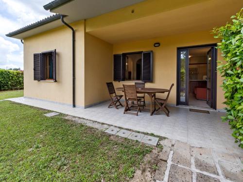 a patio with a table and chairs in front of a house at Gorgeous Holiday Home in Sorano with Swimming Pool in Sorano