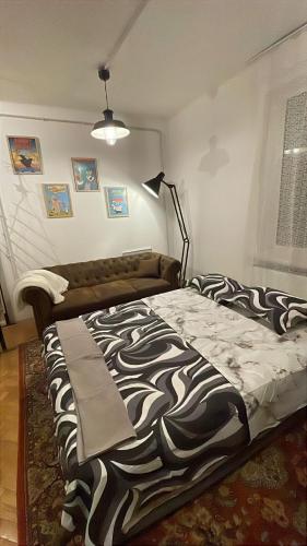 a bedroom with a bed with a zebra blanket on it at UltracentrART in Craiova